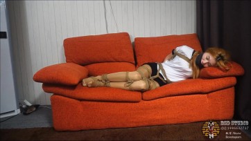 【BSD】性感美女穿着运动T恤，性感短裤，肉丝，被捆缚在沙发上动弹不得，只能试图挣扎，又将口球塞入她的口中进行堵嘴，这样还是不过瘾，后来又用胶布缠绕在她的嘴上，进行双重堵嘴。